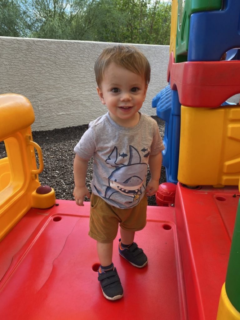 Leo smiling on the playground